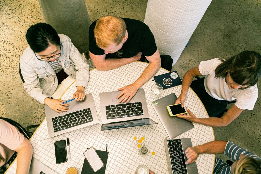 Startup team discussing import strategy in Australian office setting